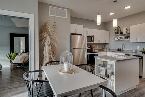 an open kitchen and dining room with a white table and chairs